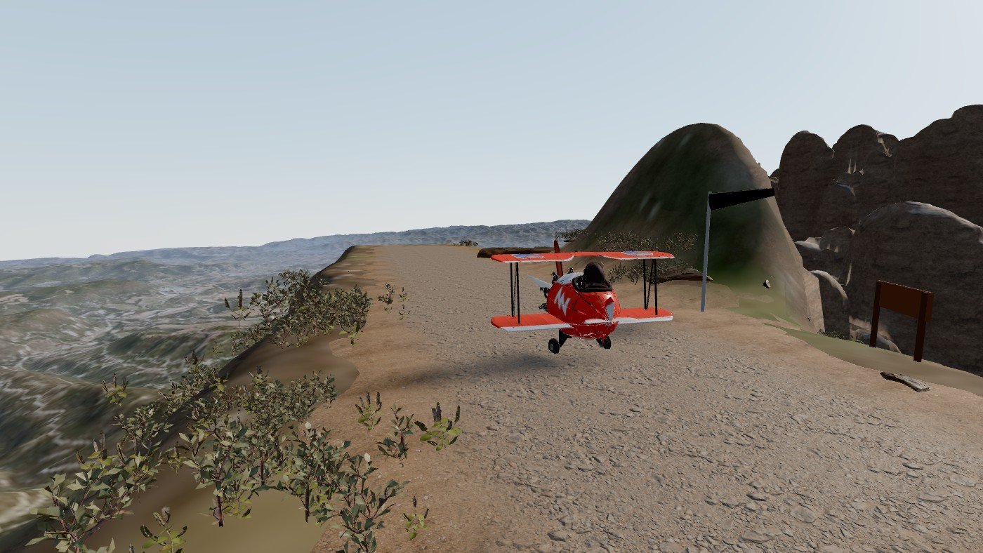 L'avioneta vermella a la pista de terra, amb el gos pilot i el punxó davant l'hèlix